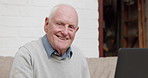 Face, smile and senior man with laptop on a sofa for streaming, social media or subscription in his home. Retirement, portrait and elderly male person happy online in living room with movies or chat