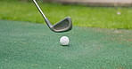 Mini golf, practice and putter on artificial grass with ball in backyard for sports, training and relax with hobby. Game, putting course challenge and club on green lawn with stroke, hit and target.
