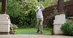 Golf, hobby and a senior man at the driving range for training or outdoor leisure during retirement. Summer, garden and an elderly person golfing with a driver for health, sports or recreation