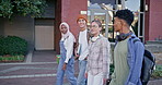 Young group, students and walking with books to class for learning, education or social chat at campus. Happy people, diversity or learners with friends for conversation or discussion at college