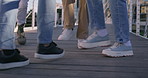 Dancing, feet and group of students in city with rhythm for celebration, winning or achievement. Legs, energy and closeup of people with groove on bridge at university campus with hip hop music.