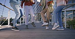 Dancing, legs and group of people in city with rhythm for celebration, winning or achievement. Feet, energy and closeup of students with groove on bridge at university campus with hip hop music.