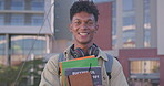 College, face and student with books for education, learning and knowledge development with literature. Happy man, portrait or academic resources at university campus for studying, test or assessment