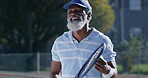 Tennis court, outdoor sport and black man with racket for fitness, workout or challenge in UK. Mature male person, exercise and training for game, match or tournament in competition, play or activity