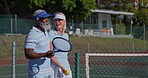 Senior, speaking and walking with interracial couple on tennis court for retirement or sports together. Exercise, fitness or hobby with happy man and woman talking for activity, bonding or training