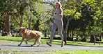 Mature woman, park and running with dog for exercise, fitness or outdoor workout in nature. Active, female person or runner with pet in jog for cardio, fresh air or bonding with animal at forest