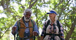 Mature, couple or hiking with stick in nature for retirement wellness, adventure or hugging on trail. Interracial people, map and walk with help in woods for fitness, bonding or talking with backpack