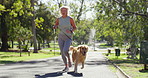 Woman, park and running with pet dog for exercise, fitness or outdoor workout in nature. Active, female person or runner with young animal for cardio, fresh air or bonding together on path at forest