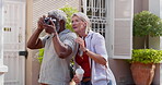 Mature couple, outdoor and camera for photography with bonding or fun, break and summer holiday. People, multiracial relationship and happy or smile as tourist on road vacation, love and memories