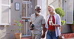 Mature couple, holding hands and outdoor with camera for bonding or fun, break and summer holiday. People, relationship and happy or smile as tourist on road for summer holiday, love and memories