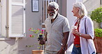 Mature couple, holding hands and outdoor with camera for bonding or fun, break and summer holiday. People, multiracial and happy or smile as tourist on road for summer holiday, love and memories