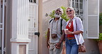 Travel, mature couple and holding hands in city for journey, support and love on trip. Sightseeing, interracial partners and touch on sidewalk for summer vacation , holiday and trust in relationship