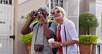 Mature couple, outdoor and camera for photography with bonding or fun, break and summer holiday. People, multiracial relationship and happy as tourist on road for vacation, honeymoon and memories