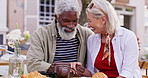 Old couple, interracial and date with love, holding hands and travel in Paris, anniversary and celebration. Outdoor, restaurant or senior man with mature woman, bonding together or care with marriage