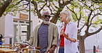 Travel, mature couple and bicycle in city for journey, support and holding hands on trip. Sightseeing, interracial partners or walking on sidewalk for summer vacation, holiday and location for tour