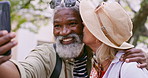 Selfie, hike and senior couple with love, kiss or funny with happiness, hug or romance. Outdoor, interracial or mature woman with elderly man, travel or embrace with nature, picture or capture moment