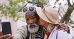 Selfie, hike and old couple with kiss, hug or picture with happiness, hug or romance. Outdoor, interracial or mature woman with elderly man, travel or embrace with love, nature and capture moment