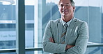 Arms crossed, management and smile with business man at window of corporate office for development. Confident, mission and portrait of mature employee in suit at work, proud of professional career