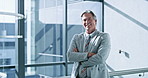 Arms crossed, proud and smile with business man at window of corporate office for development. Confident, portrait and professional with mature employee in suit at workplace for career growth