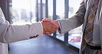 Business people, men and handshake in office with welcome for introduction, greeting or b2b meeting. Company merger, employees or shaking hands in building for partnership deal, agreement or contract