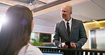 Executive, phone and receptionist at hotel front desk for conversation, appointment and check in info. Business man, thinking and concierge for guest registration, booking and reservation with mobile