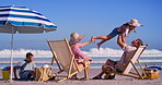 Parents, kids and lifting at beach with happiness for fun, break and holiday for bonding in Mauritius. People, family and smile or excited at ocean for summer vacation, adventure and relax with fun