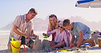 Family, sea and building a sandcastle on vacation, love and laughing together for humor in nature. Parents, support and playing games with kids on holiday, outdoor and funny conversation with toys