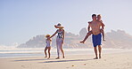 Water, travel and family in vacation, outdoor and children with parents, happy and journey for bonding. Beach, people and kids in holiday, mom and dad with youth, relax and adventure in weekend