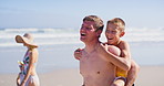 Walking, piggy back and family on beach for tropical summer holiday, bonding and relax together. Mom, dad and kids on ocean vacation with smile, waves and island adventure on happy weekend morning