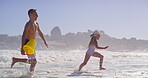 Siblings, kids and smile at beach with running for fun, bonding and support in Bali. People, children and happy or excited with playing ocean on summer holiday, adventure and break to relax and love