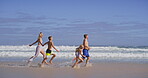 Playful, parents and kids with running on beach, family vacation and bonding by seaside. Waves, mother and father with children for holiday journey, connection and happy with holding hands on ocean