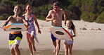 Parents, children and surfboard on holiday at beach for leisure activity, running or energy with laughing. Happy family, people and kids in swimwear on tropical island for surfing or travel adventure