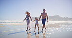 Walking, family and happy with holding hands on beach, travel vacation and bonding by seaside. Blue sky, mother and father with girl for holiday adventure, connection and child jump with joy on ocean