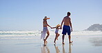 Walking, parents and child with holding hands on beach, family vacation and bonding by seaside. Blue sky, mother and father with girl for holiday journey, connection and security by waves on ocean