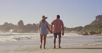 Back, holding hands and walking with couple on beach together for holiday, travel or vacation. Love, relationship or romance with man and woman on sand by ocean or sea of tropical island paradise