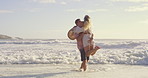 Beach, lift and playing in ocean with couple outdoor together for anniversary, honeymoon or romance. Having fun, laughing or love with man and woman in sea of tropical island paradise for bonding
