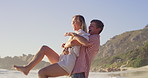 Carry, love and kicking with couple on beach together for honeymoon holiday, travel or vacation. Anniversary, laughing or playful with happy man and woman outdoor in nature for bonding or romance