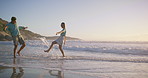 Sea, water splash and couple for romance, honeymoon and travel for fun, kick and love. Woman, man and beach for date to show partner sunset play, adventure or happy bonding and joy on Miami holiday