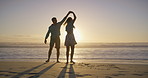 Beach, playful dance and couple holding hands for romance, honeymoon and travel for fun, dip and love. Woman, man and sea for sunset, date and adventure or happy bonding with joy on Miami holiday