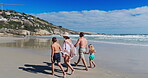 Back, family and holding hands with walking on beach for summer vacation, tropical journey and bonding together. Parents, children and ocean water with holiday fun, calm morning and travel adventure