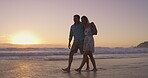Beach, hug and couple on holiday, laughing and bonding in nature, conversation and romance on date. Love, man and happy with woman, travel and peace of ocean, relax and getaway for lovers and sunset