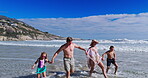 Parents, kids and walking with love at beach for summer vacation, tropical journey and bonding together. Family, children and holding hands with water for holiday, calm morning and travel adventure