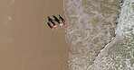 Above, family and holding hands with walking on beach for summer vacation, tropical journey and bonding together. Parents, children and ocean water with holiday fun, calm morning and travel adventure