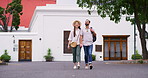 Happy, couple and holding hands for travel in city with sightseeing view, urban tourism and bonding together. Smile, people and walking with vacation commute, adventure and romantic for relationship
