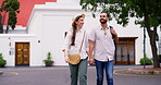 Smile, couple and holding hands for travel in city with sightseeing view, urban tourism and bonding together. Happy, people and walking with vacation commute, adventure and romantic for relationship
