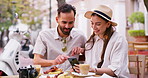 Love, date and phone with couple in cafe for restaurant review, streaming and social media. Website, happiness and summer vacation with man and woman in outdoor coffee shop for romance and food blog