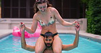 Love, pool party and couple shoulder carry with fun, splash and bonding at hotel or resort. Swimming, romance and man with woman, water and laughing for summer event, holiday celebration or adventure
