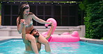 Laughing, pool party and couple with adventure, splash and bonding at hotel or resort. Swimming, shoulder carry and man with woman, water and balance for summer event, holiday celebration or fun