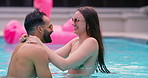 Swimming pool, smile and couple on holiday, laugh or hug outdoor for talking on vacation. Happy, man and woman in water with swimsuit for romantic love, spinning or playful dance on date to relax