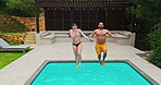 Swimming, couple and jumping in pool with freedom for travel adventure, recreation and bonding together at resort. Energy, people and holding hands with water splash for fun at vacation destination